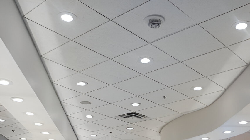 A ceiling with lights and a white wall